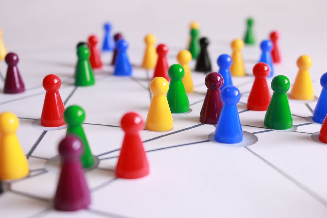 Crafting Captivating Headlines: Your awesome post title goes here A strategic arrangement of colorful pawns connected on a game board, symbolizing networking and teamwork.
